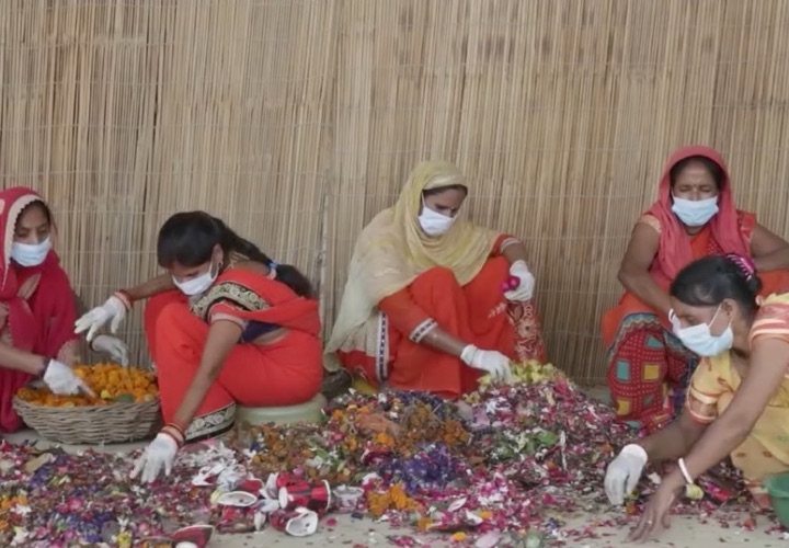 Women sorting temple flowers at a recycling unit